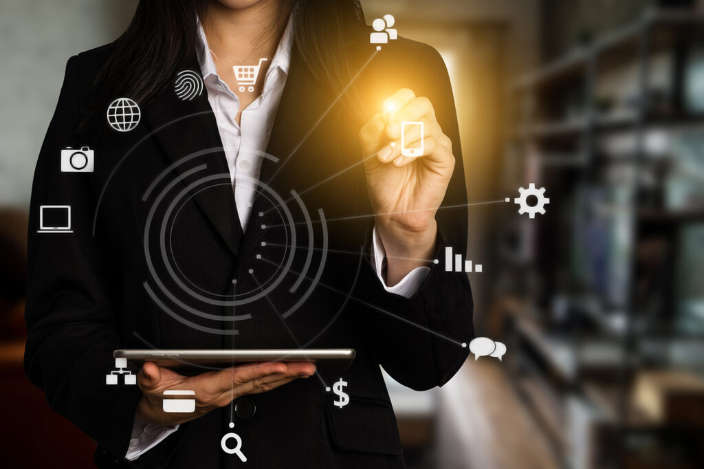 A woman holding a tablet with technology icons surrounding her.